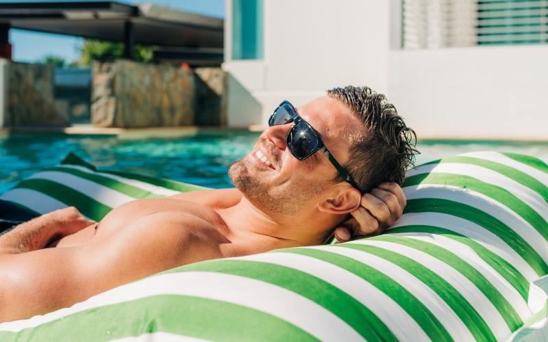 a man lying in a pool float